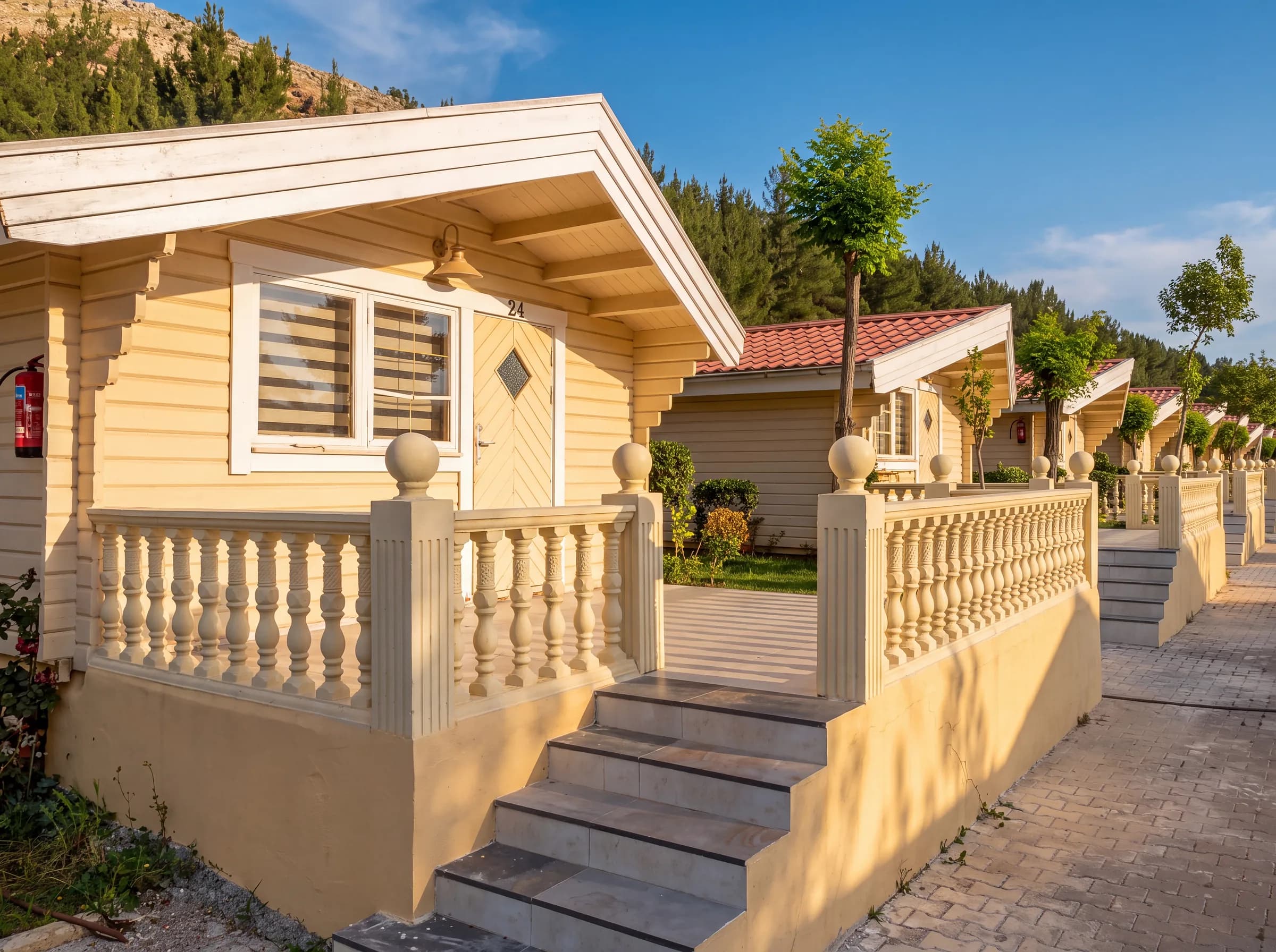 The front of a cabin with its steps and stone balustrade
