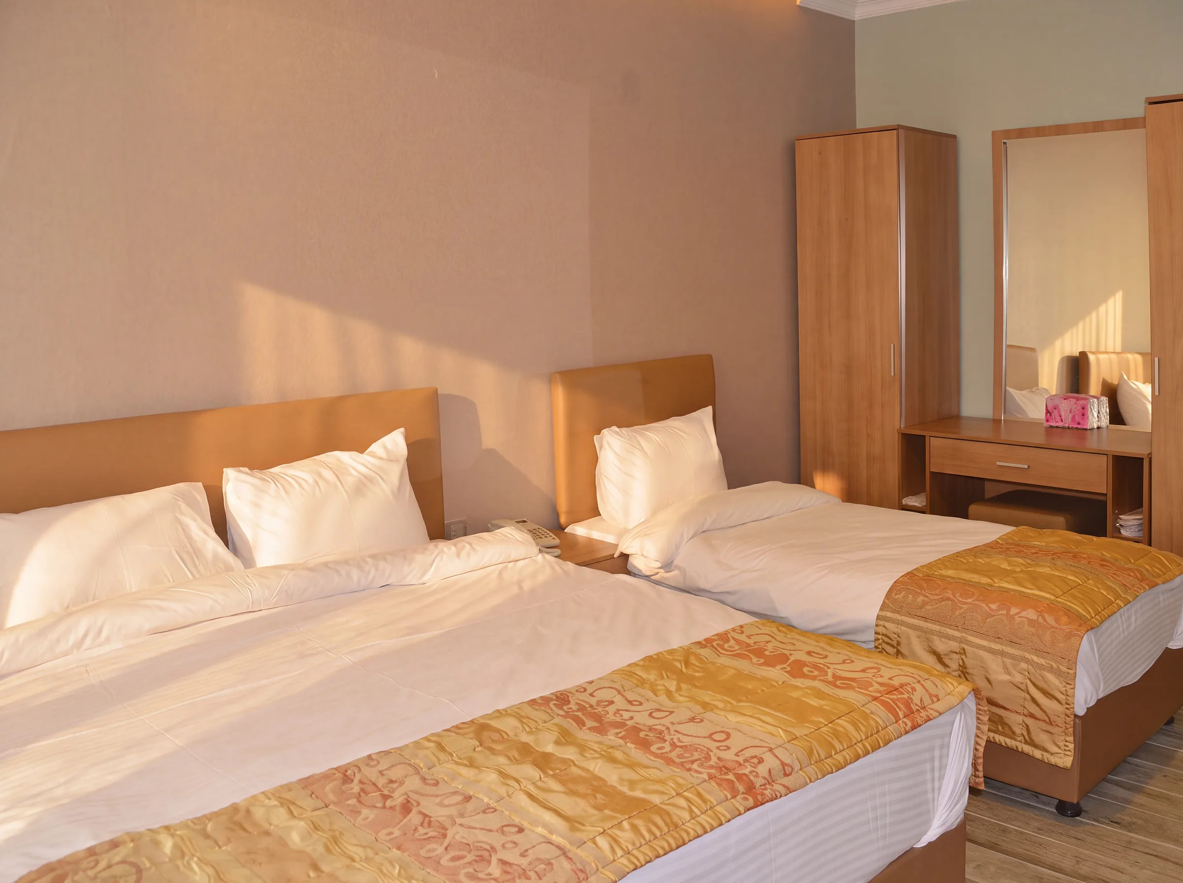 A hotel room with a double bed and a single bed