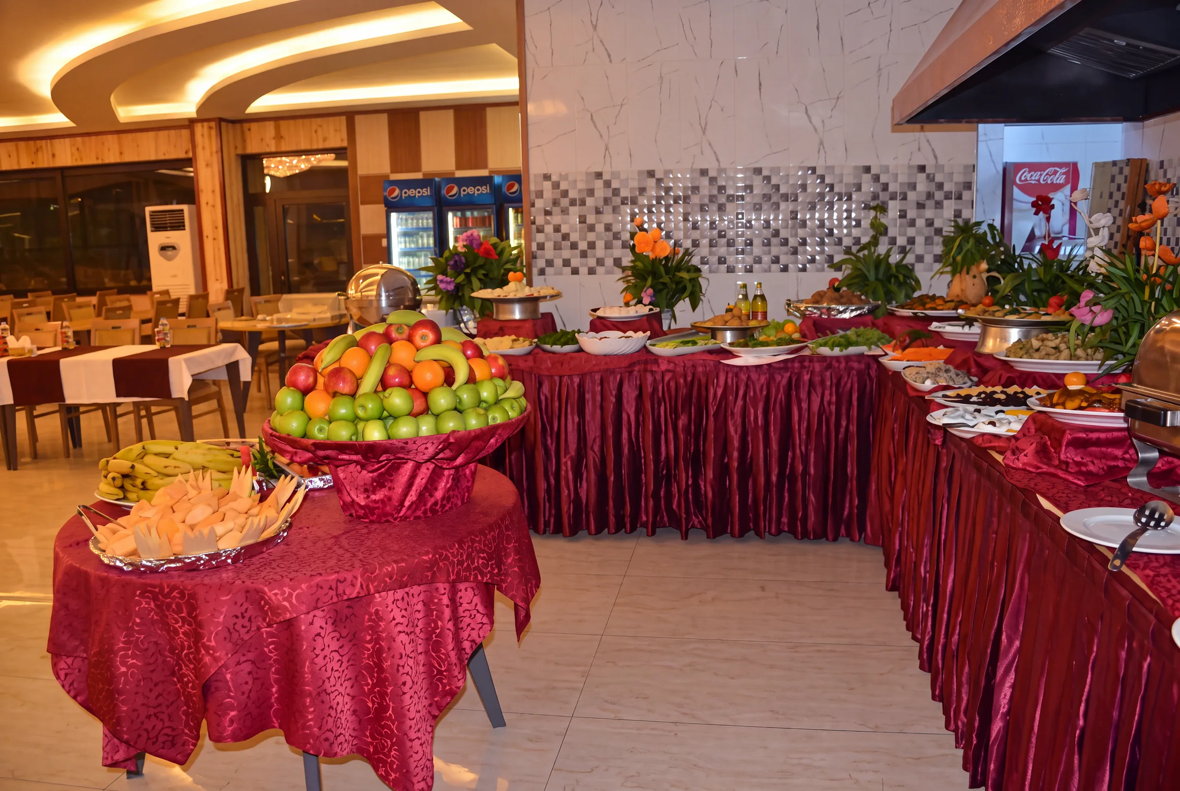 The restaurant buffet with fruit and a selection of dishes.